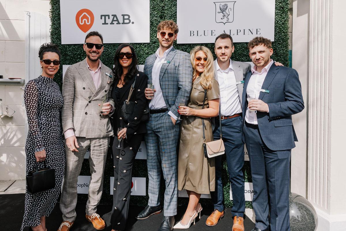 Oracle FM team at an event with Blue Alpine and TAB signage