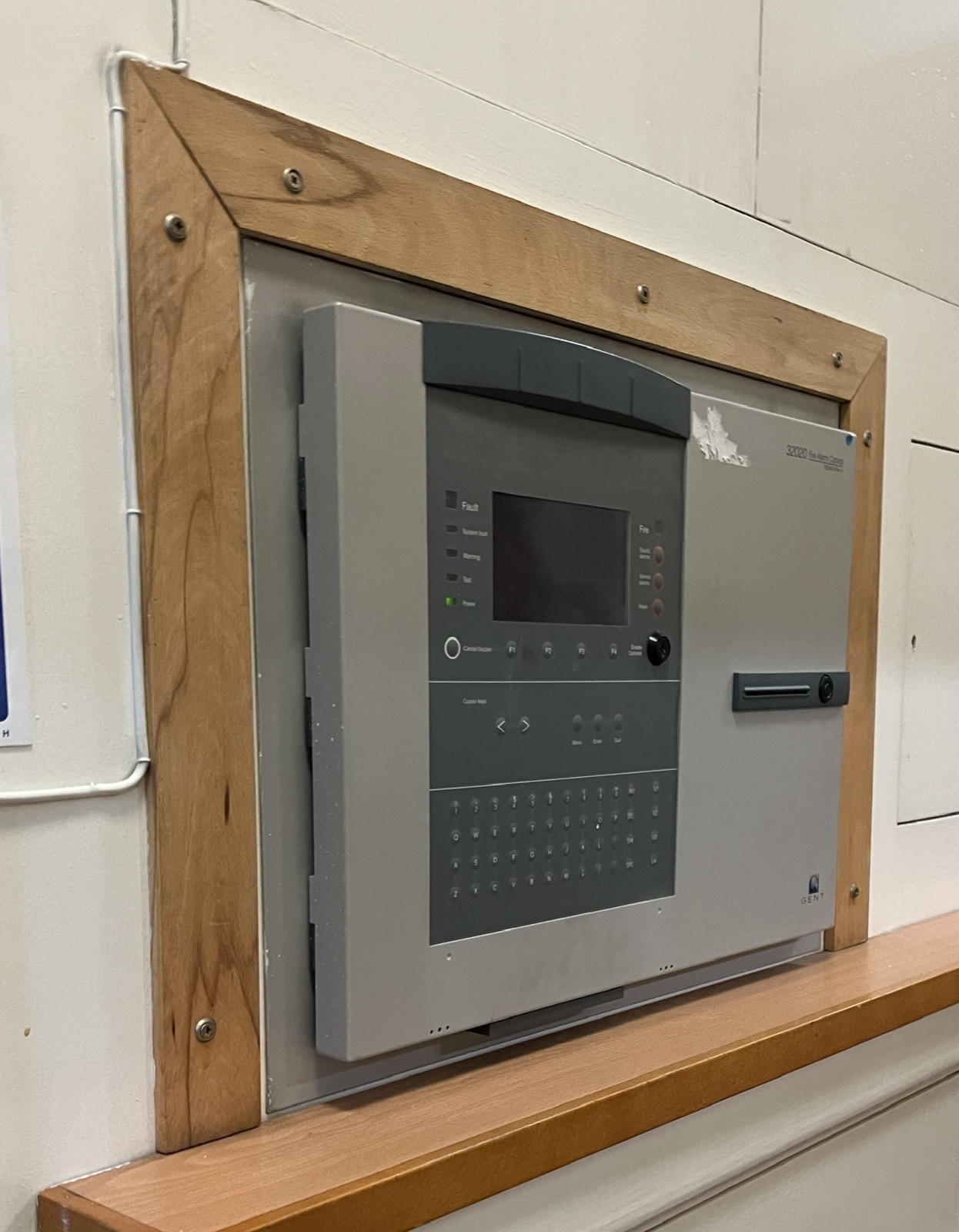 Wall-mounted fire alarm control panel with display and control keys